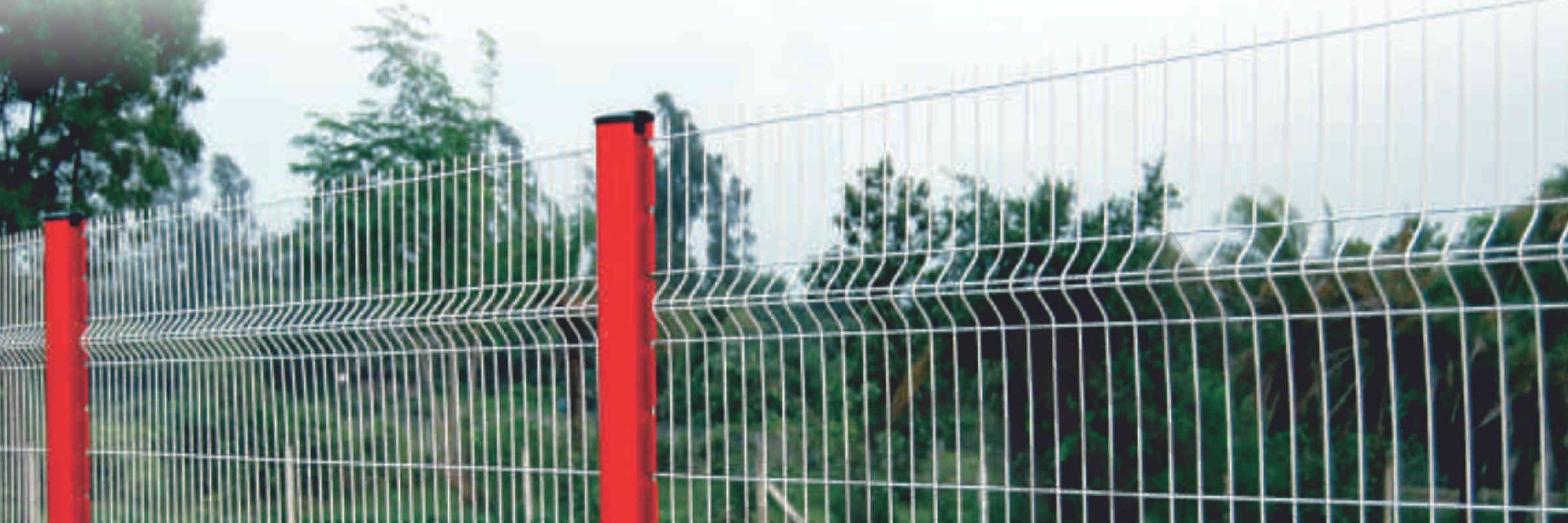 Rigid 3D welded-mesh perimeter fencing with profiled panels and red steel posts